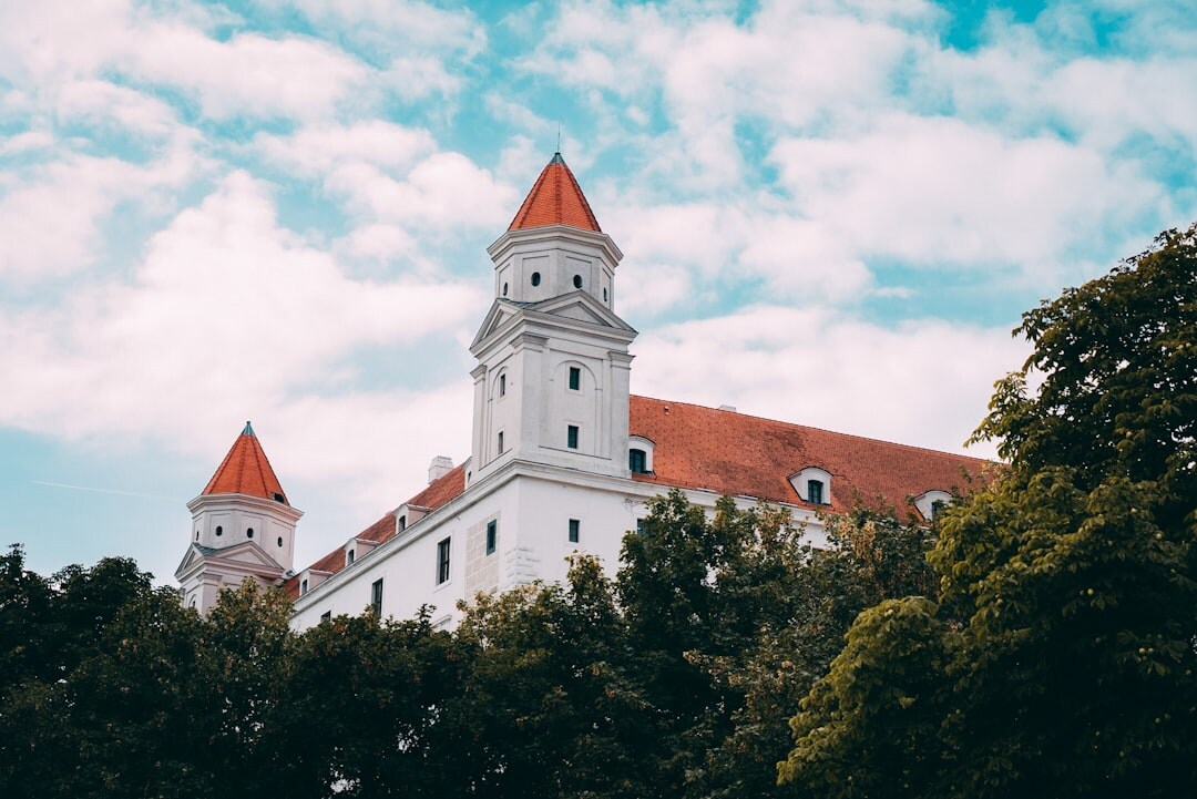 Group of Slovak seniors on a guided tour in front of a historic castle
