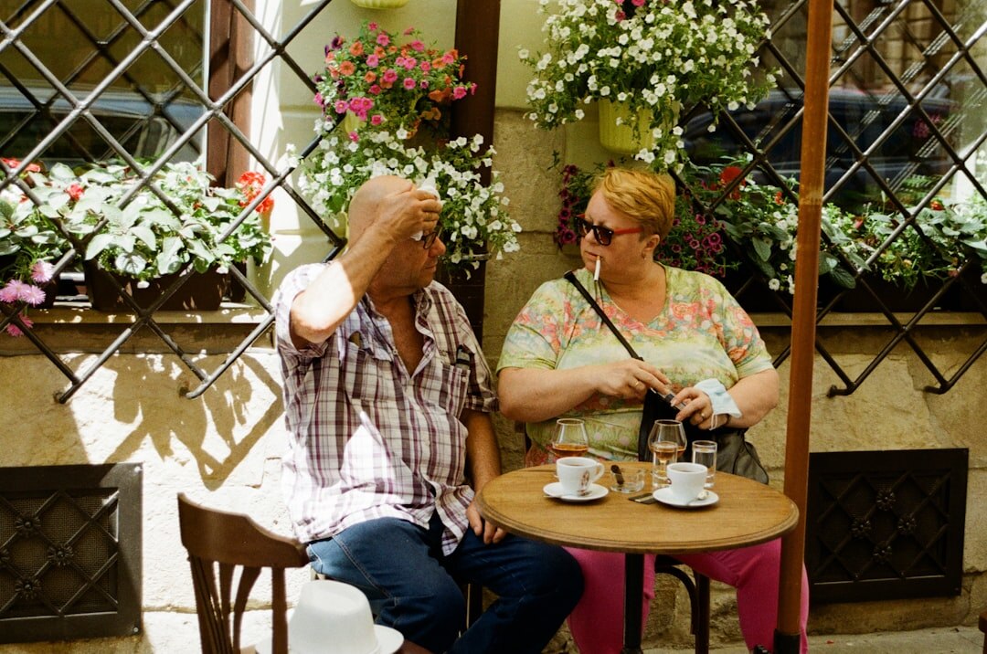 Senior Slovak couple smiling in a cafe holding a membership discount card