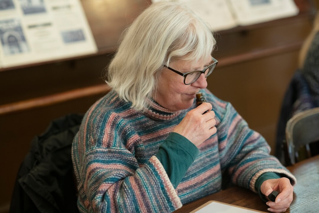 Slovak senior woman filling out a registration form at a desk
